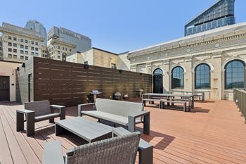 A wooden deck with a bench and a table at LiveWell Apartments, Pittsburgh